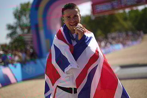 Men's mountain bike race: Thomas Pidcock, of Britain, bites the gold medal